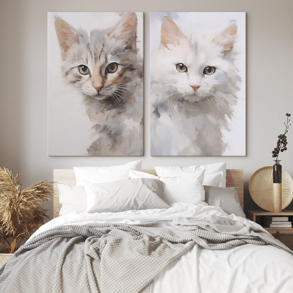 Two cats with their heads turned to the side