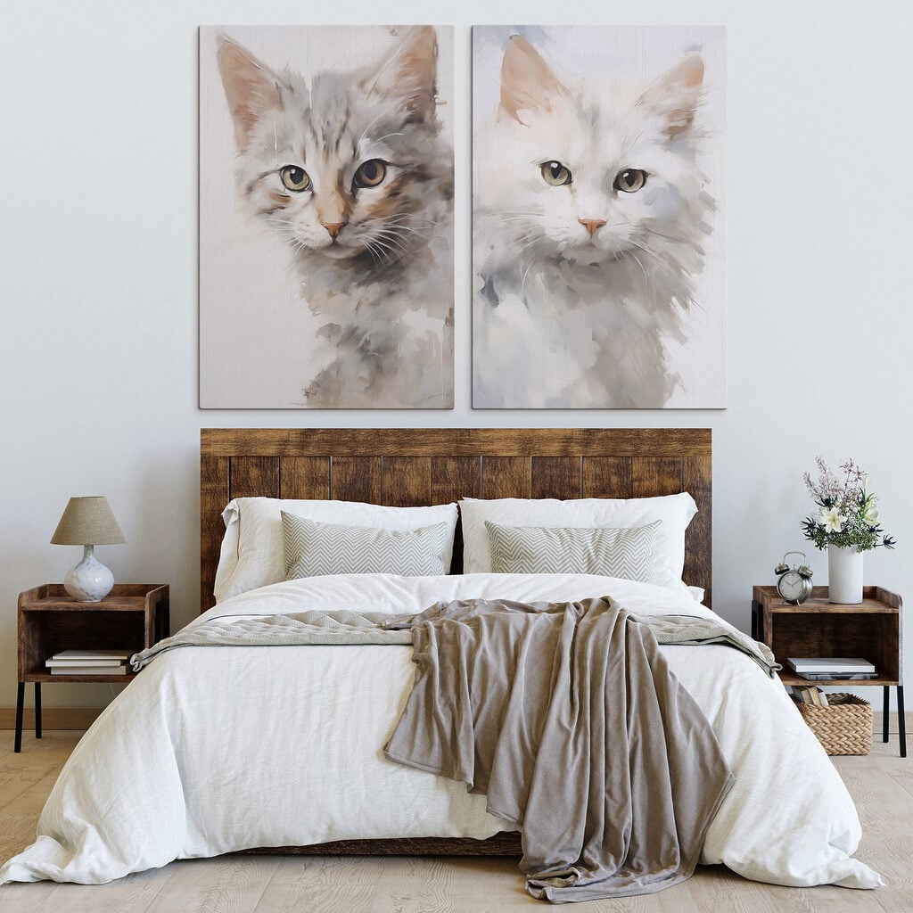 Two cats with their heads turned to the side